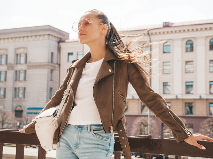 streetwear woman in a brown jacket with a blue jean