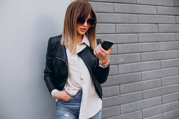 A woman in black bomber jacket with a jean urban style
