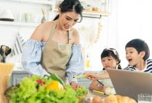 asian young single mother making food while taking care child kitchen 74952 2072